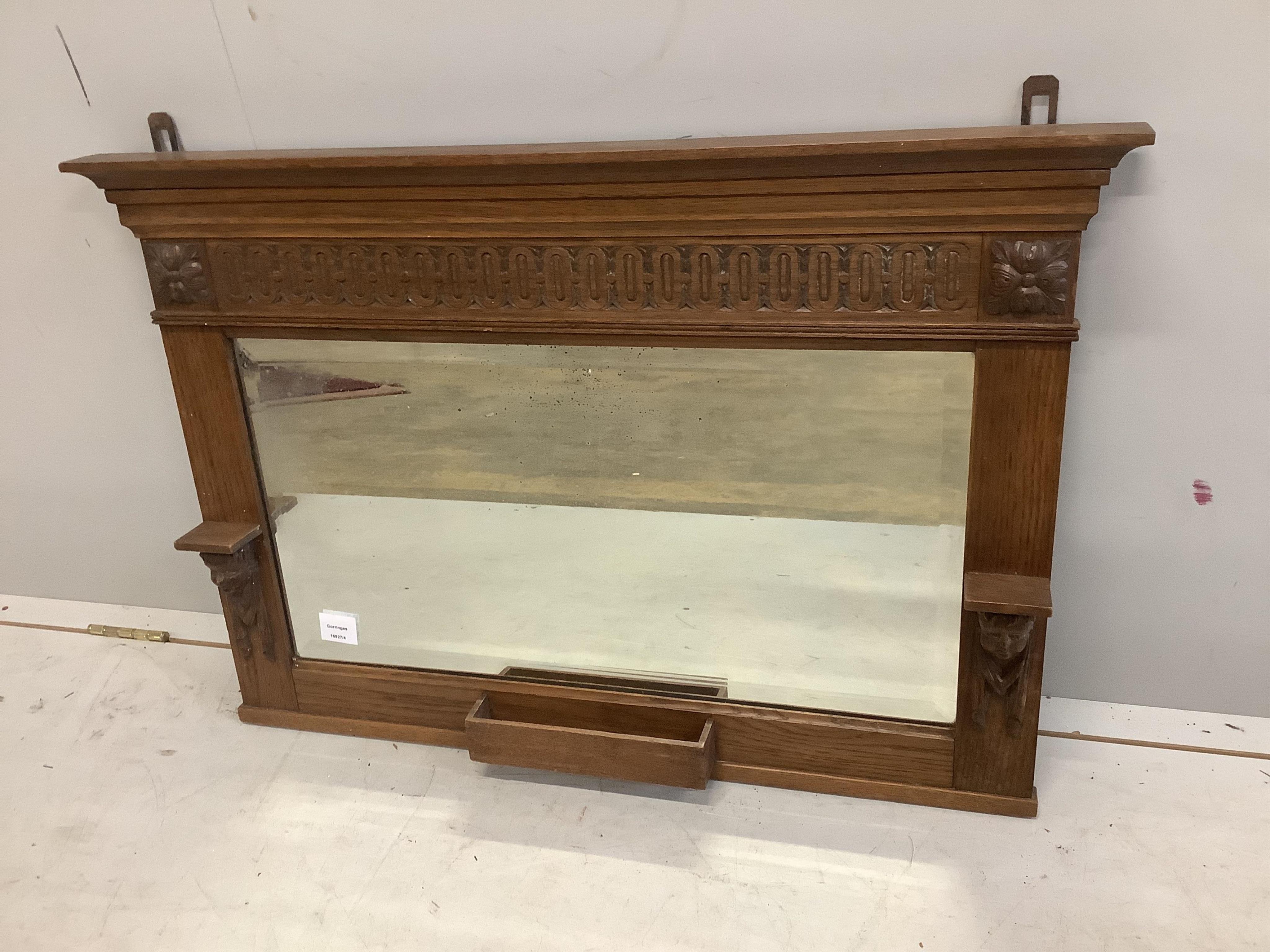 An early 20th century oak overmantel mirror, width 88cm, height 59cm. Condition - fair to good